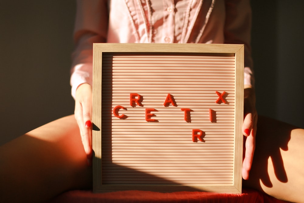 a woman holding a sign that says crack it up