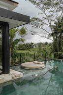 a large pool with a lounge chair next to it