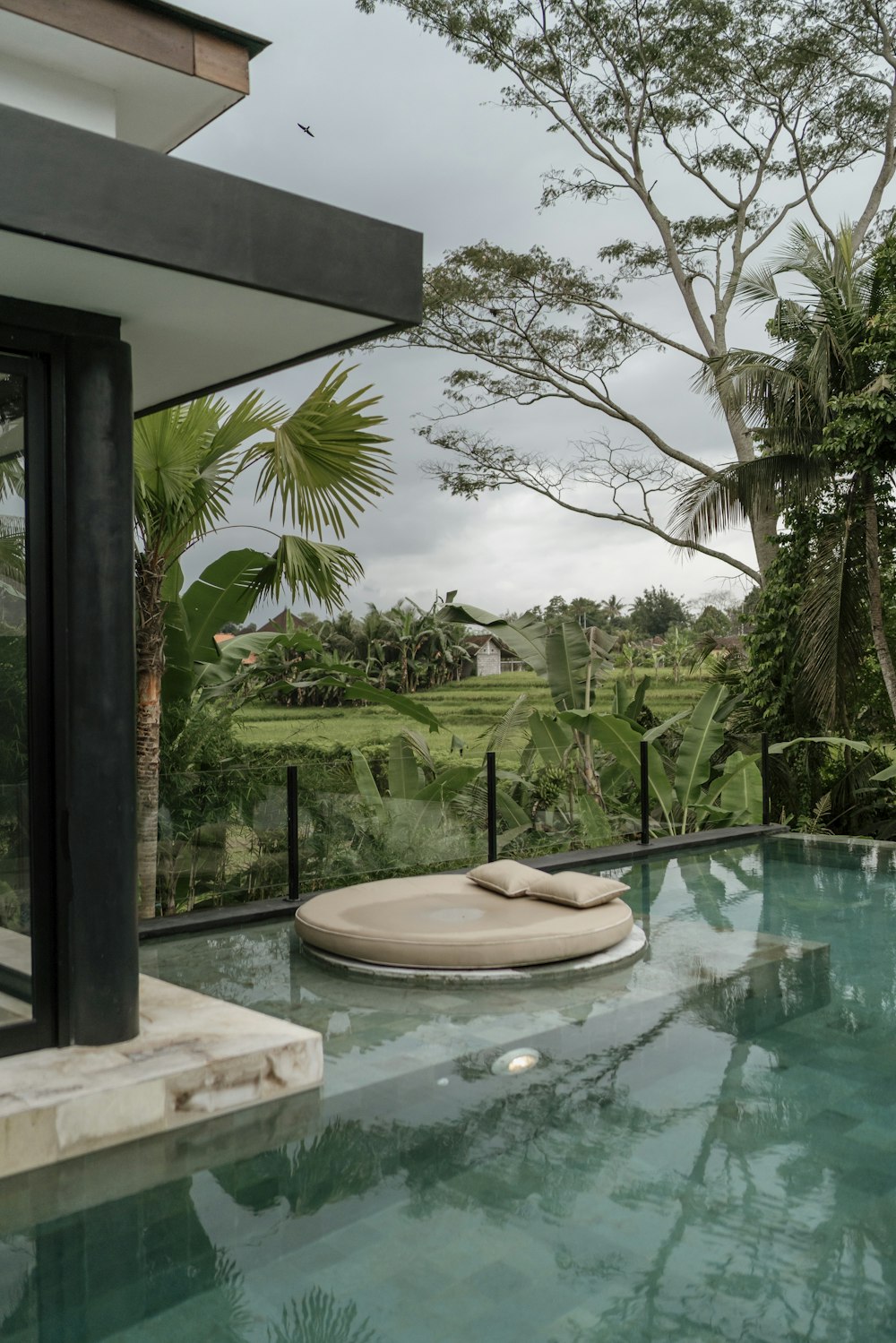 a large pool with a lounge chair next to it