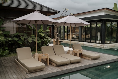 a group of lounge chairs sitting next to a swimming pool