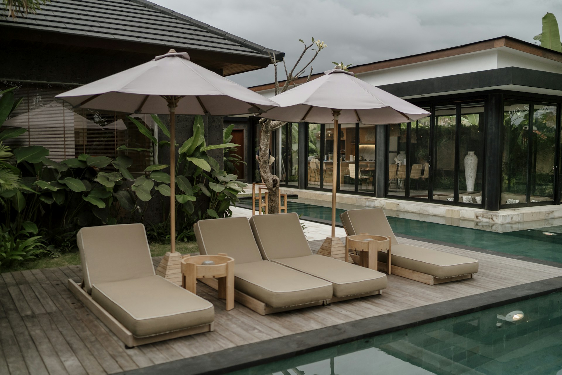 a group of lounge chairs sitting next to a swimming pool