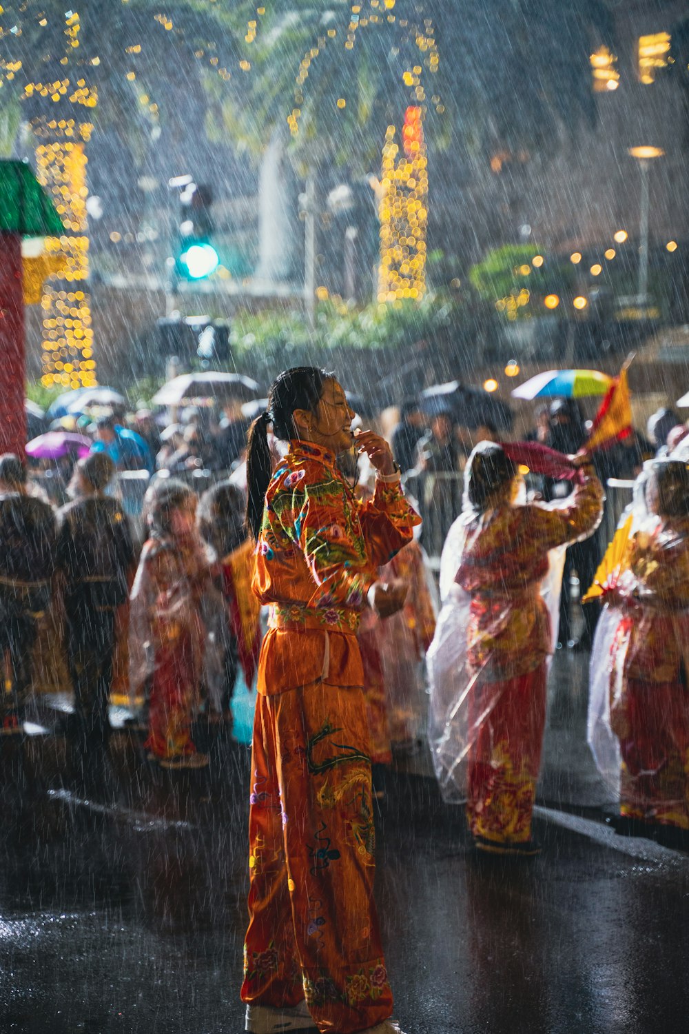 a group of people standing in the rain with umbrellas