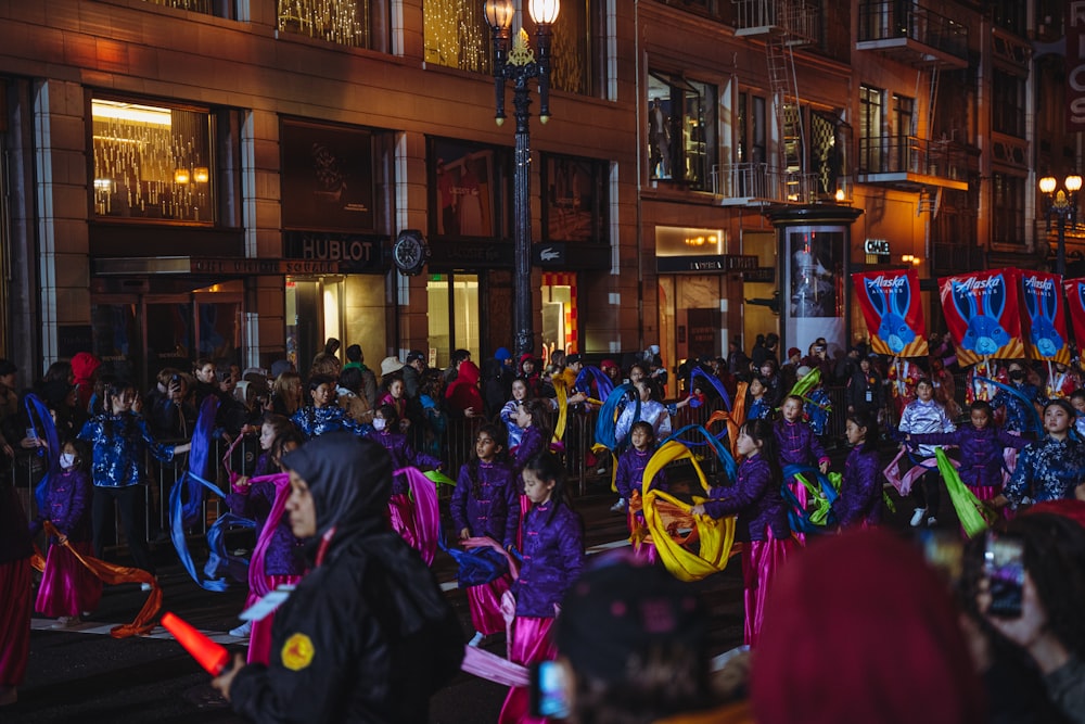 a crowd of people standing around each other in front of a building