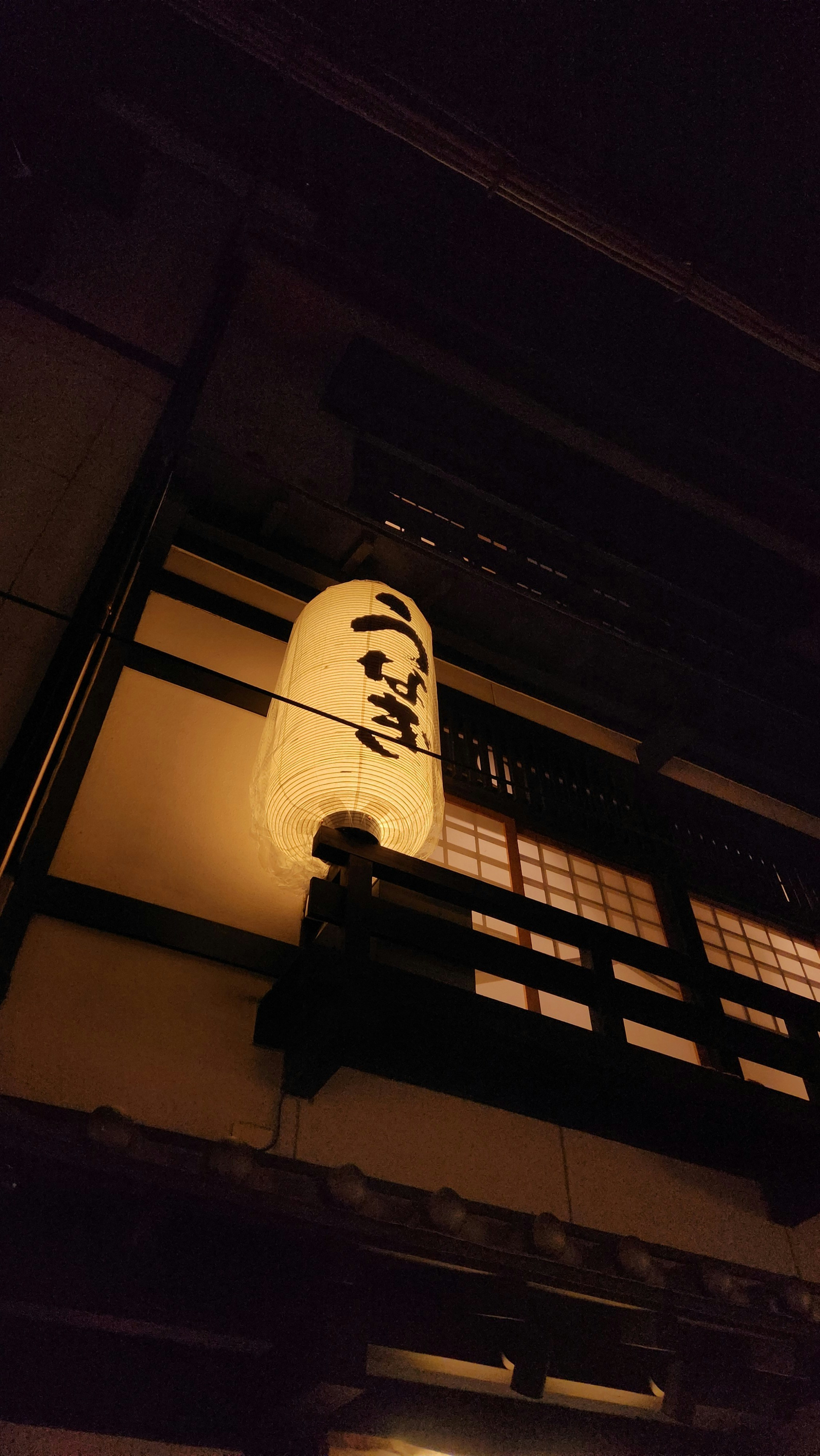 a lantern hanging from the side of a building