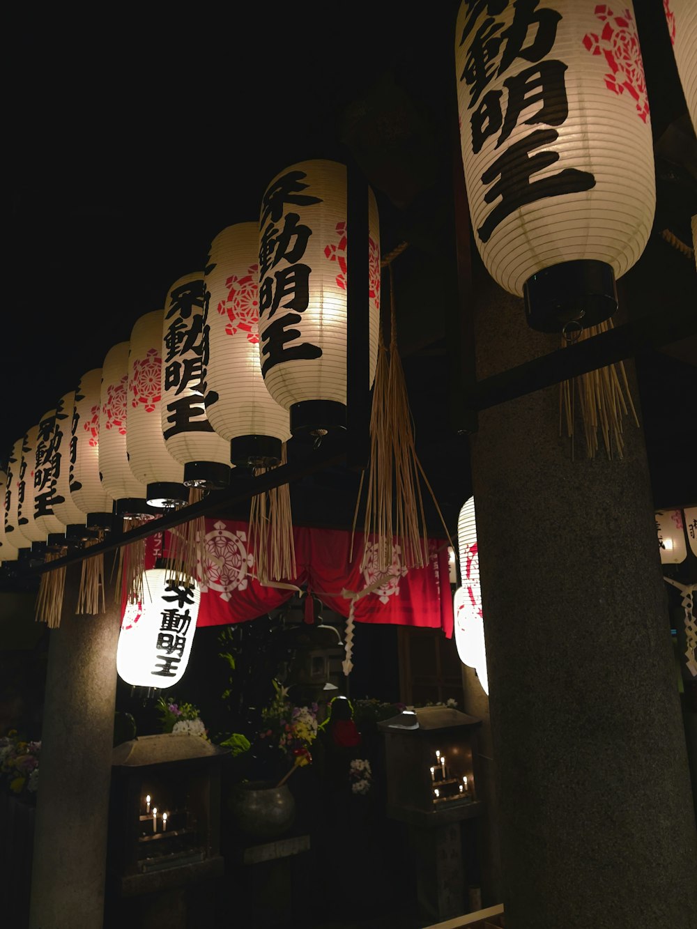 a group of chinese lanterns hanging from the ceiling