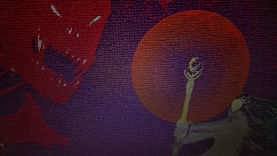 A stylized dragon with sharp teeth and glowing eyes appears on the left, facing a figure holding a glowing staff on the right. A large red circle, giving the impression of a sun or moon, dominates the background, with dark, textured colors surrounding the scene.