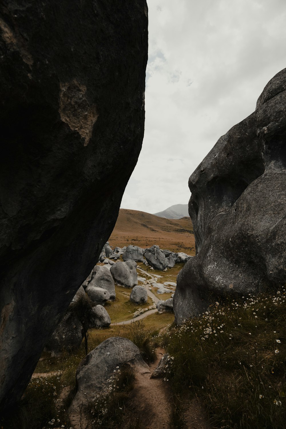 a rocky landscape with a path between two large rocks