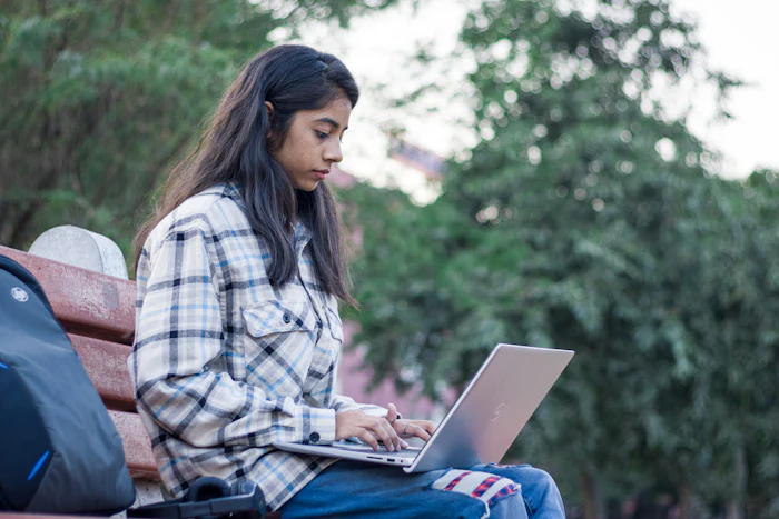 Student studying on a laptop outdoors