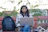 a woman sitting on a bench using a laptop computer