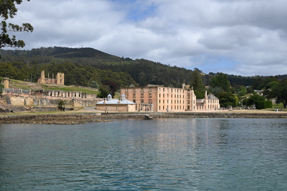 a large building sitting on the side of a lake