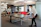 A group of executives enjoying a ping pong match around a glass table in a modern, elegant lounge setting.