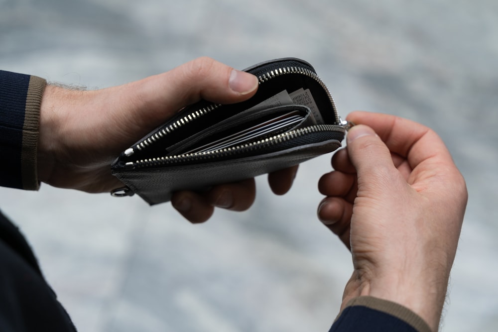 a person holding a wallet in their hand