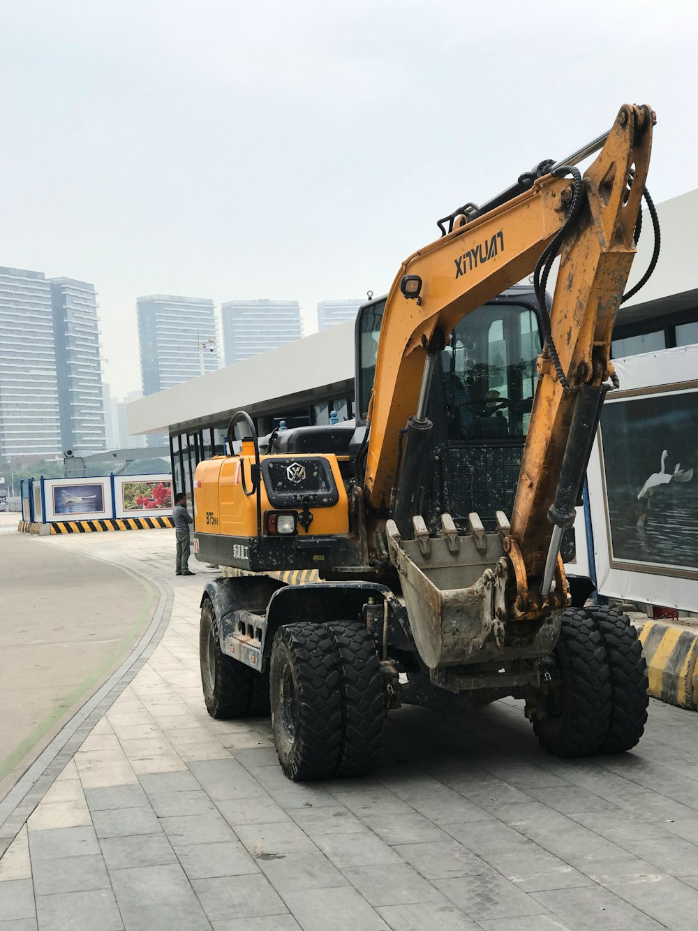 a construction vehicle is parked in front of a bus