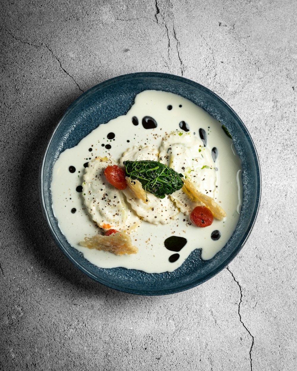 a blue plate topped with food on top of a table