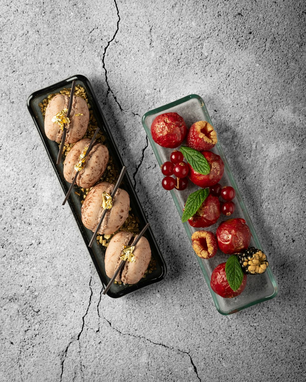 a couple of trays of food sitting on top of a table