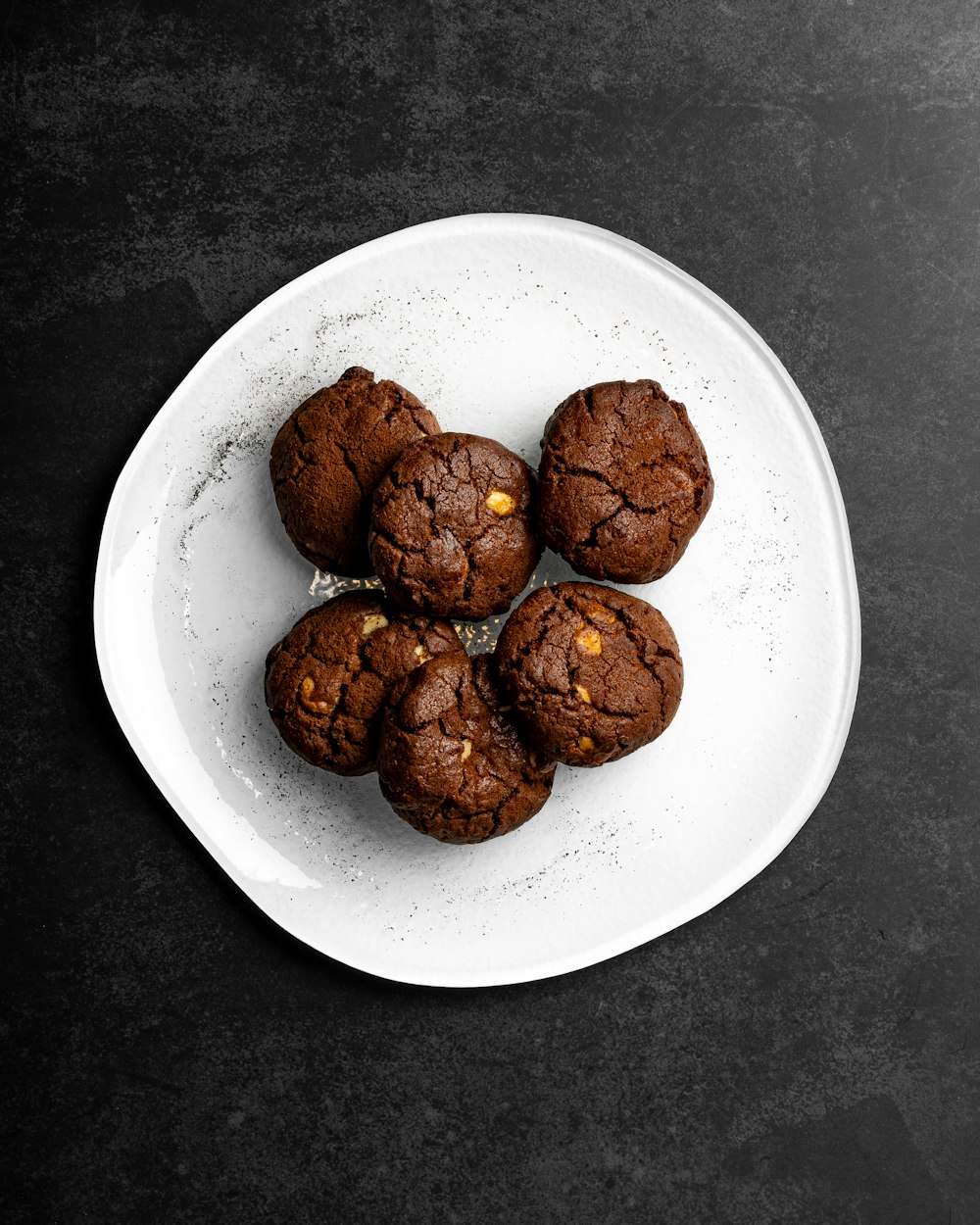 a white plate topped with chocolate cookies on top of a table