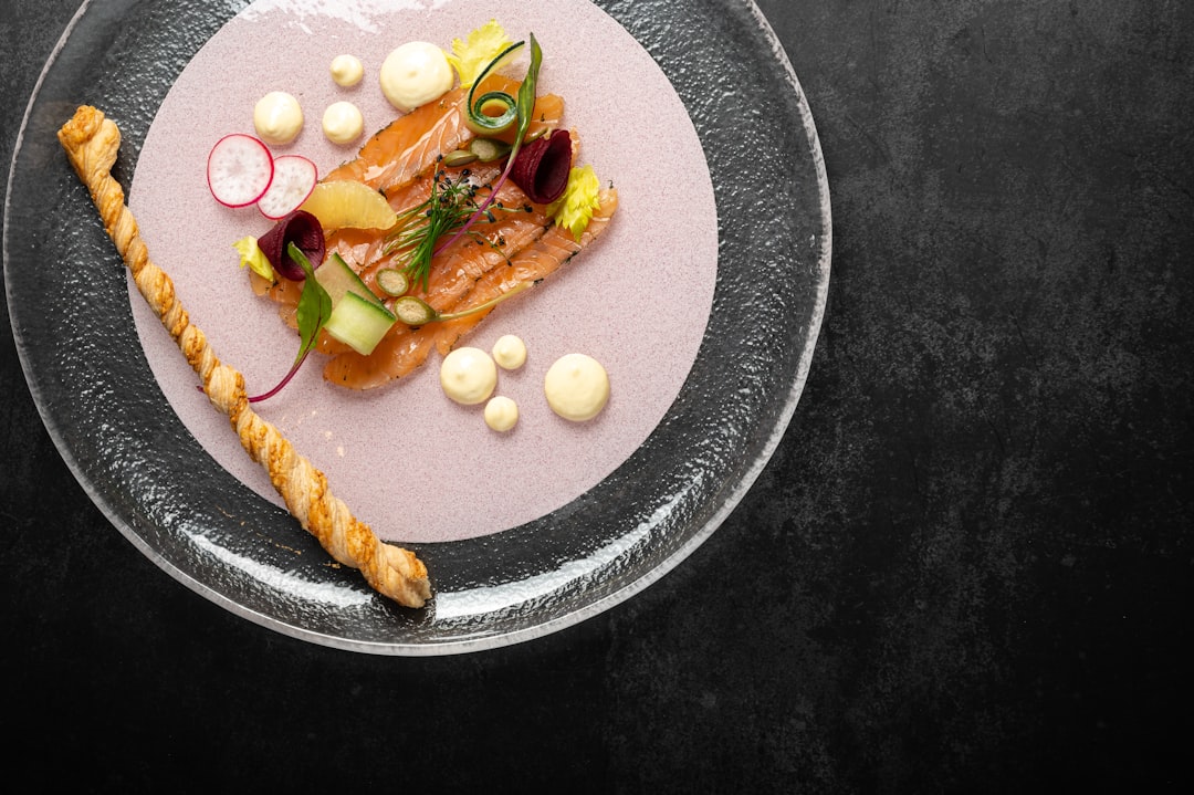 a plate of food on a black table,