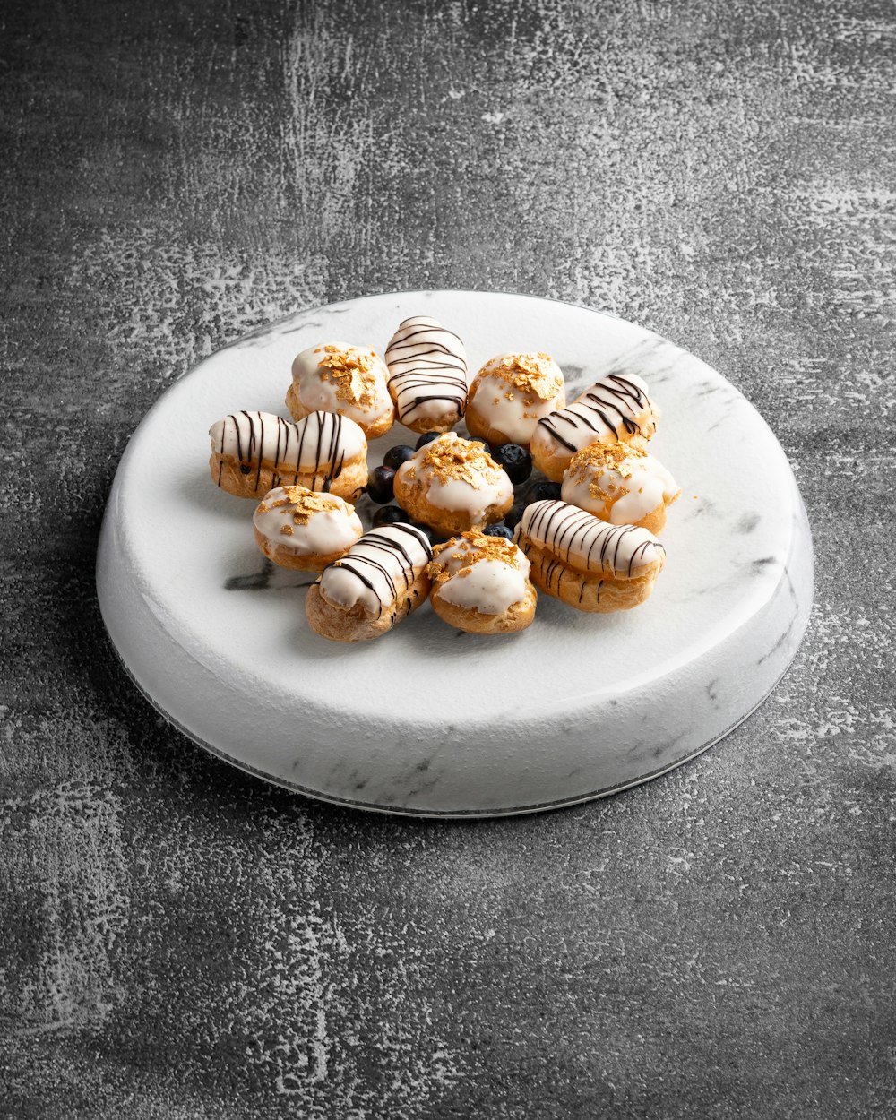 a white plate topped with cookies covered in icing