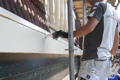 a man is painting the side of a building