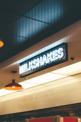 a sign that reads milkshakes hangs from the ceiling