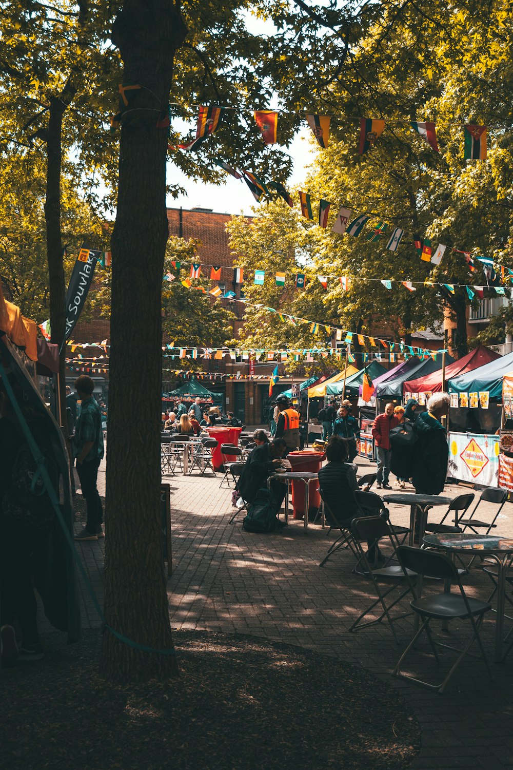 a group of people sitting at a table under a tree