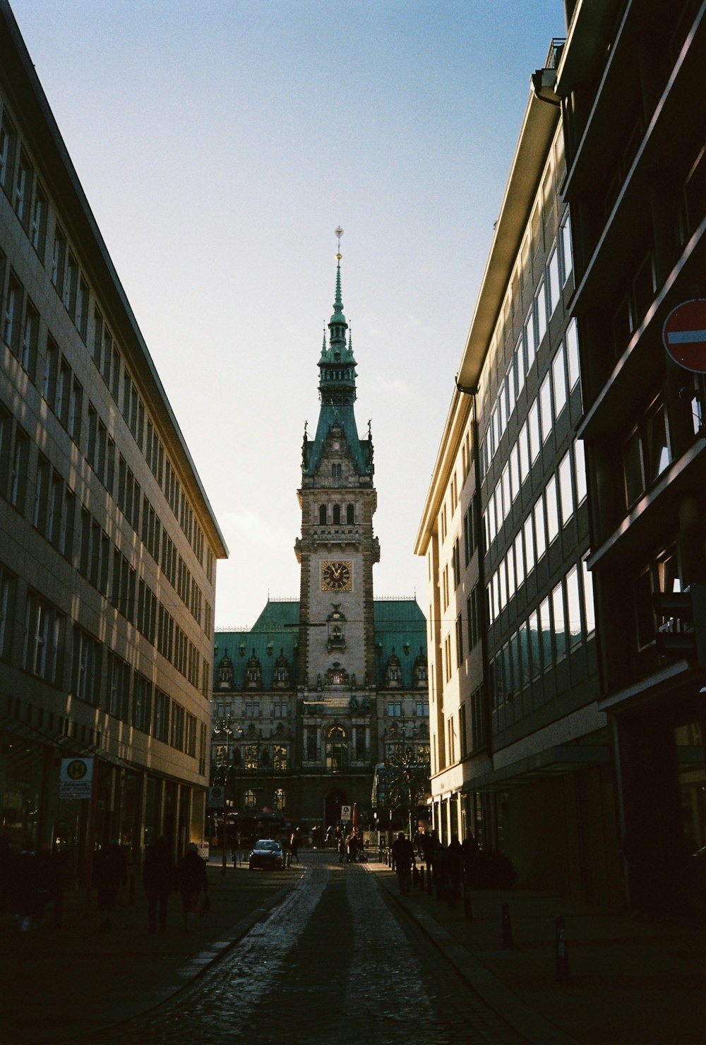 a clock tower towering over a city street