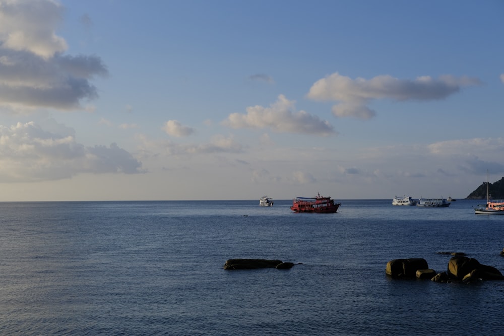 a group of boats floating on top of a large body of water