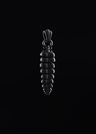 Close-up of a sleek Atalaia pendant glowing softly against a deep blue-black background.