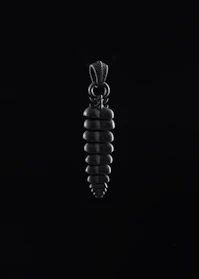 Close-up of a geometric pendant featuring sharp edges and a polished metal surface.