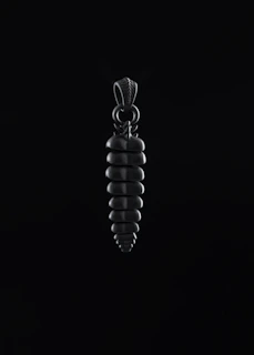 A stylish pendant necklace catching sunlight, highlighting its elegant curves and shine