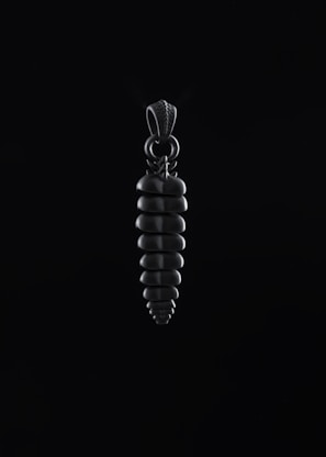 Chrome heart pendant hovering gently, edges reflecting deep etched highlights in space