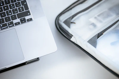 Close-up of a compact notebook with a clean keyboard and visible brand logo, placed on a minimalist desk.