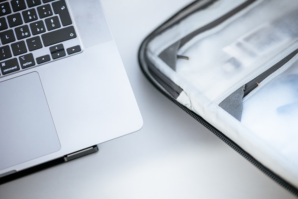 a laptop computer sitting on top of a white table