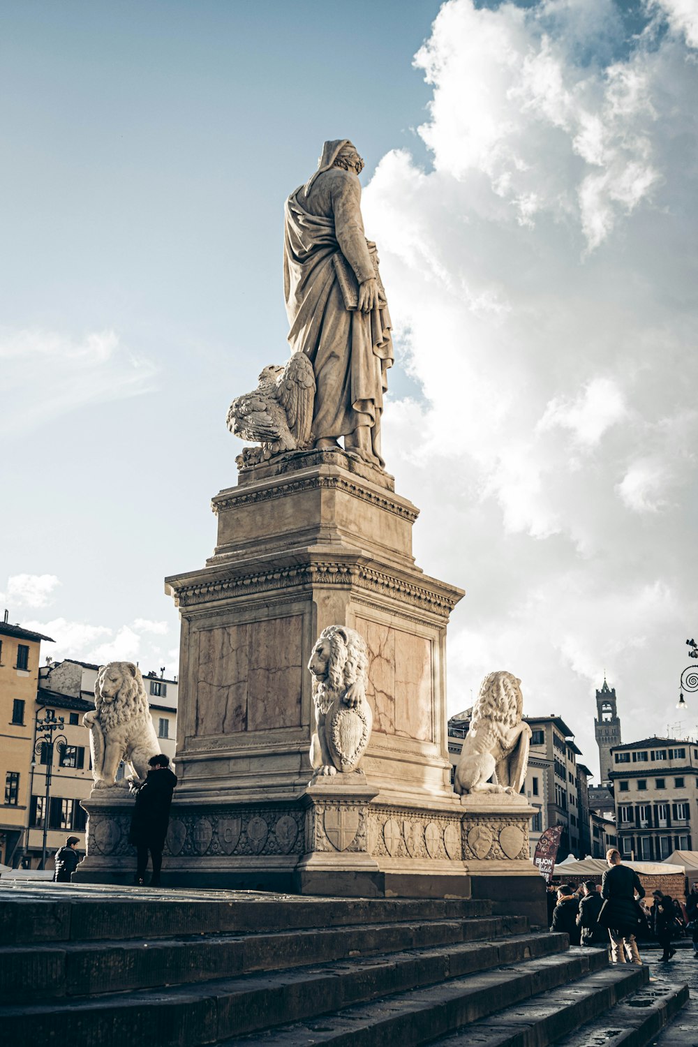 a statue of a woman standing on top of a set of steps