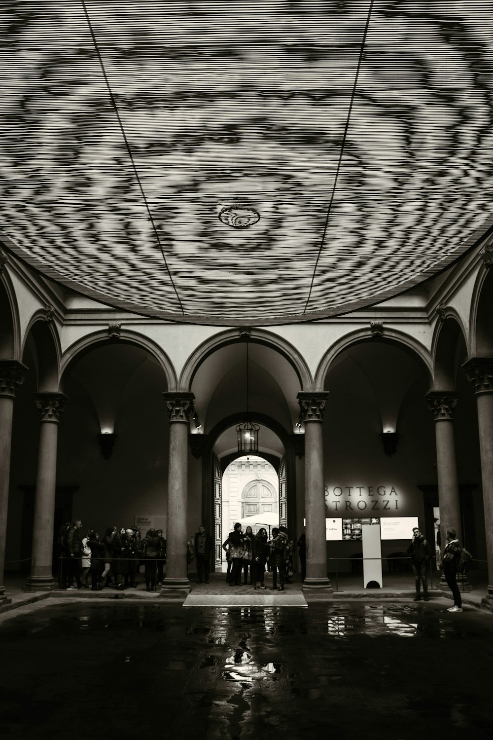 a black and white photo of people in a building