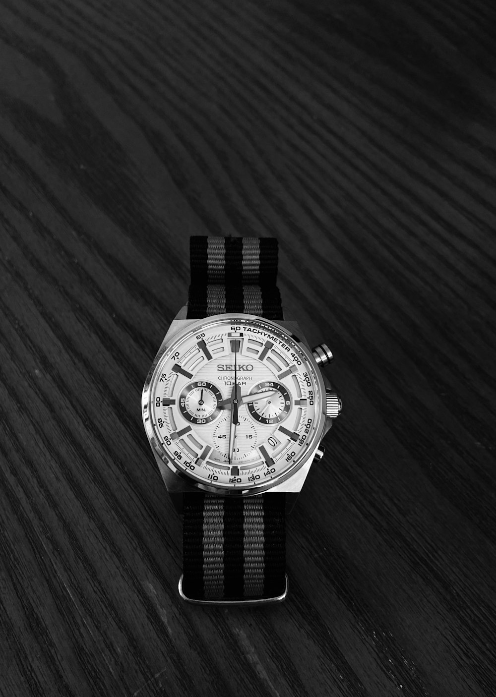 a watch sitting on top of a wooden table