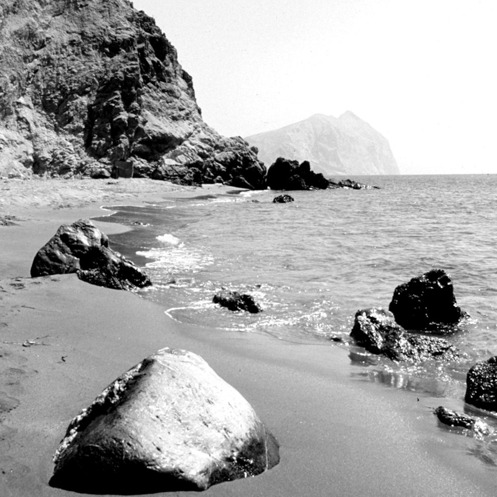 a black and white photo of a rocky beach