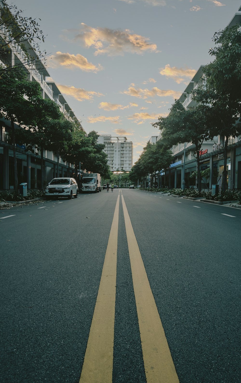 a street lined with buildings and parked cars