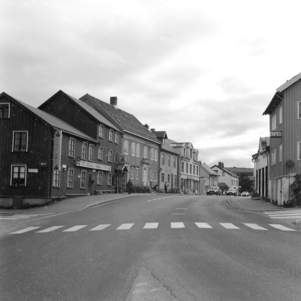 a black and white photo of a street in a small town