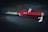 A classic red Swiss Army knife is placed on a dark background, showcasing its multi-functional design with visible tools such as a blade, corkscrew, and bottle opener.
