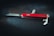 A classic red Swiss Army knife is placed on a dark background, showcasing its multi-functional design with visible tools such as a blade, corkscrew, and bottle opener.