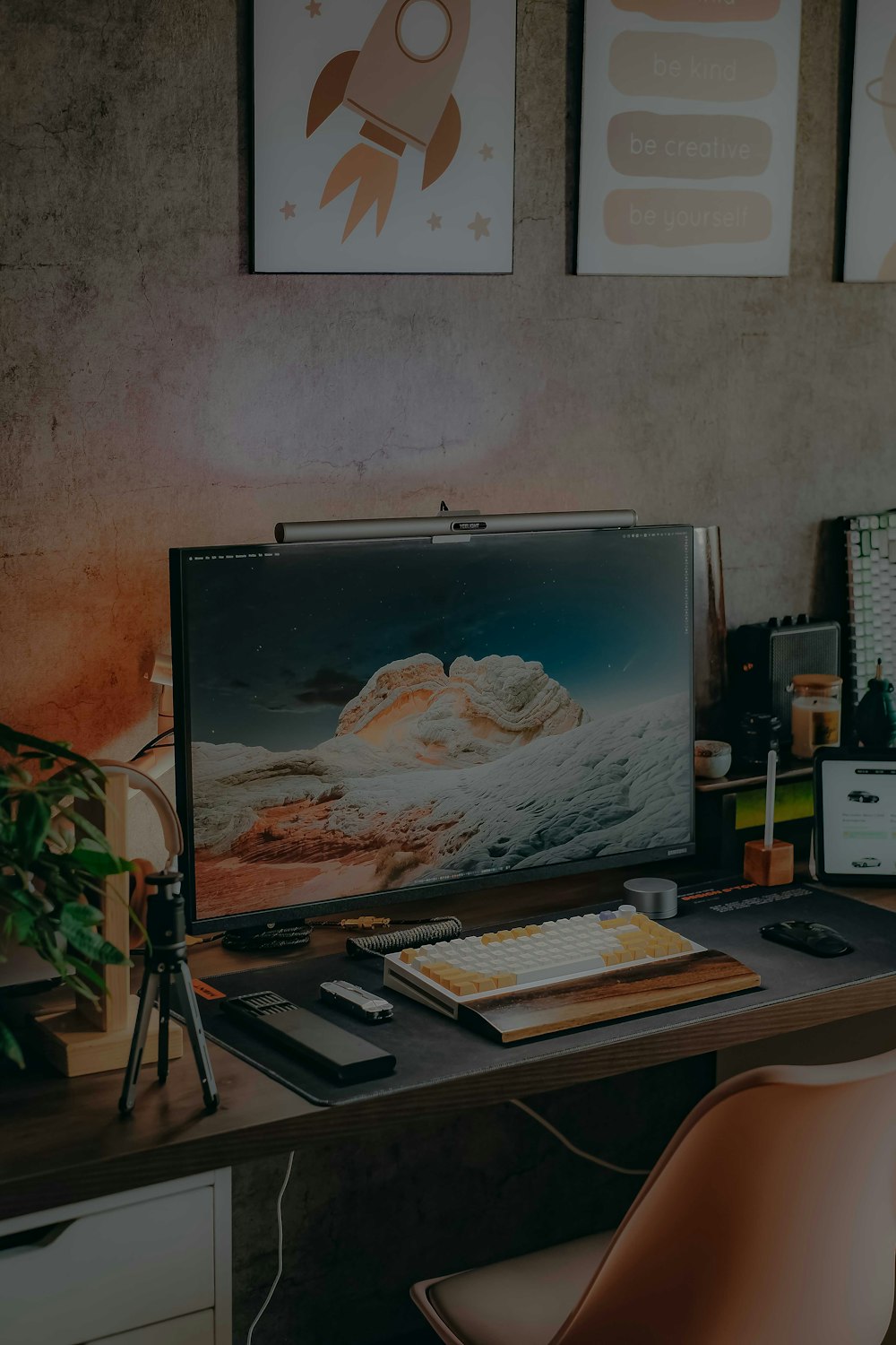 a desk with a computer and a laptop on it