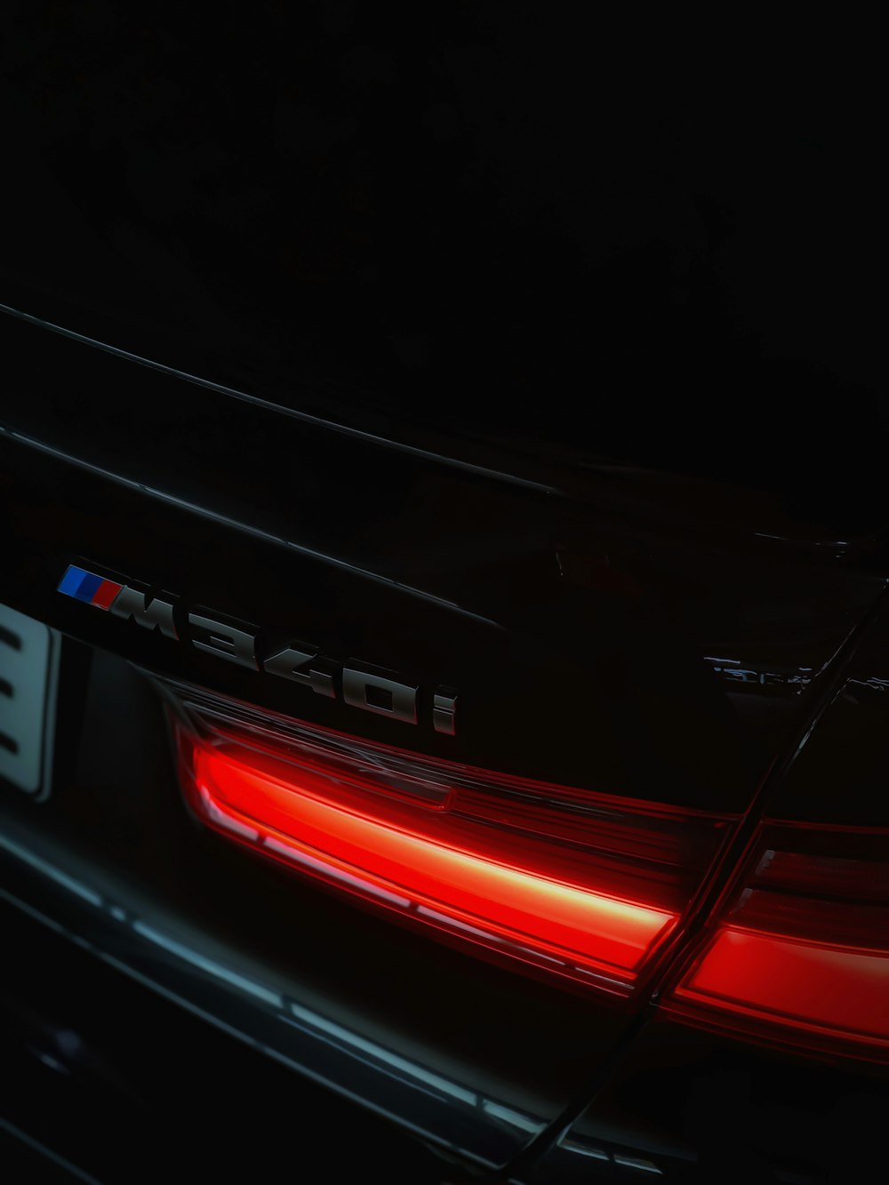 the rear end of a bmw car in the dark