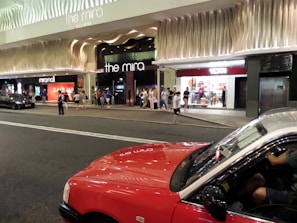 Taxi waiting outside a popular shopping mall in Kuwait, ready for quick pickup.
