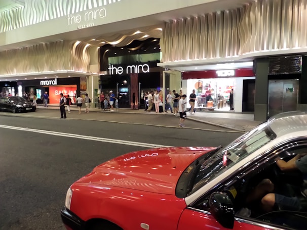 A group of happy passengers getting into a taxi outside a shopping mall in Al Khiran.