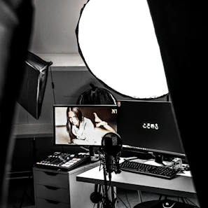 A compact green screen setup hanging behind a stylish streaming desk.