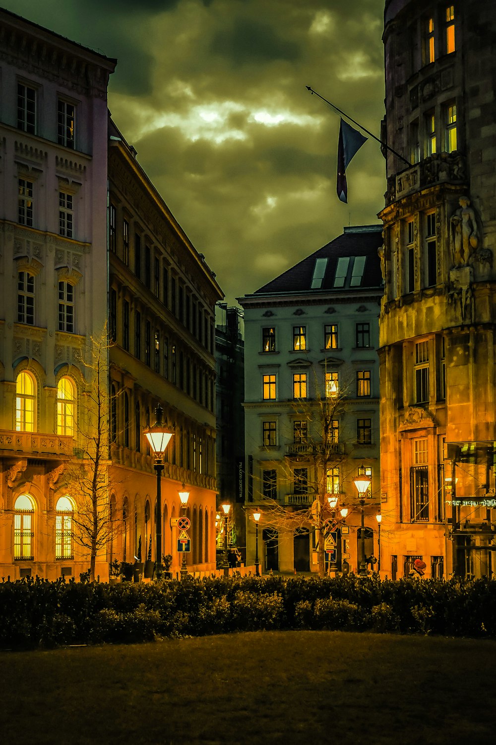 a city street at night with buildings lit up