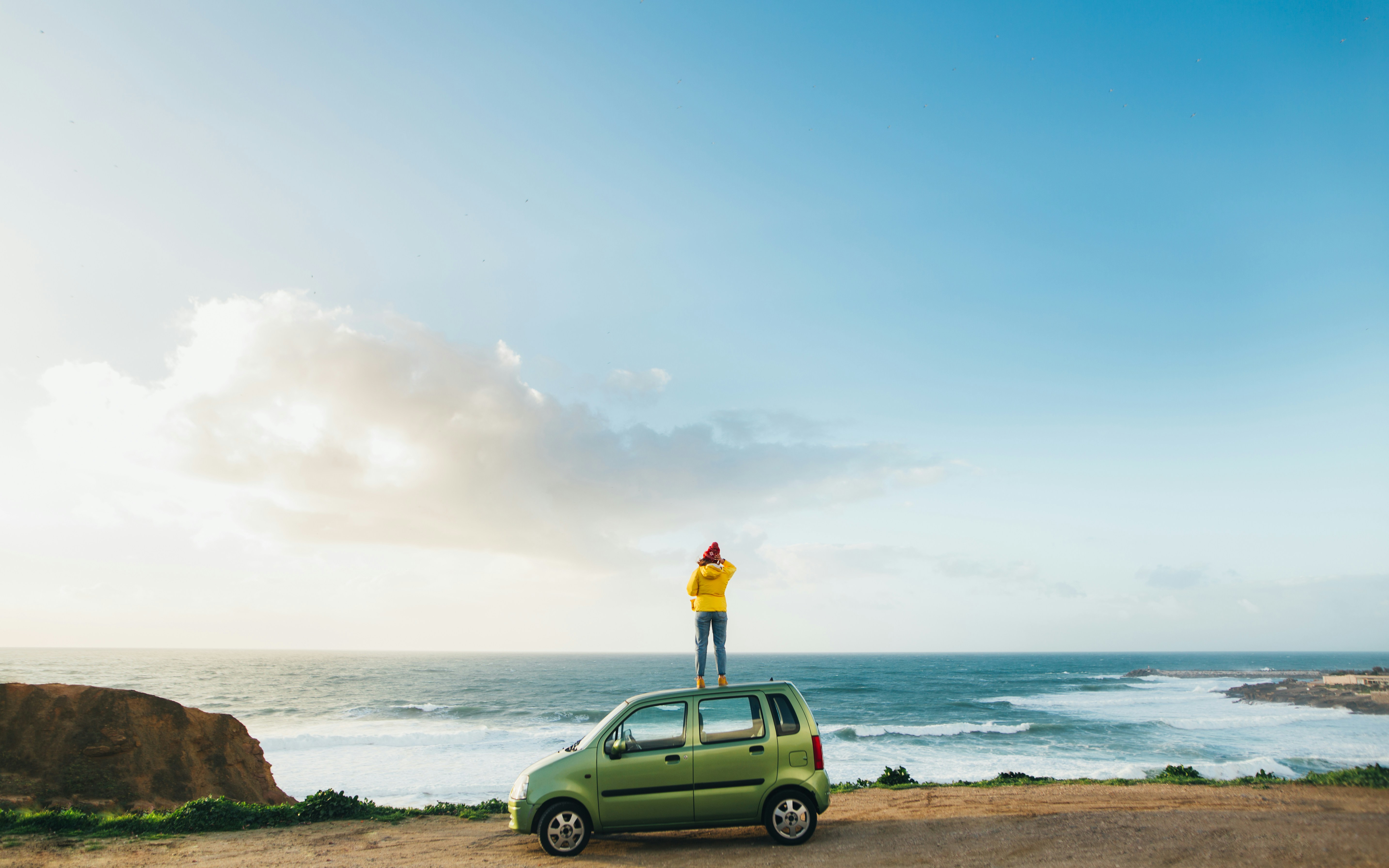 A person standing on top of a green car photo – Free Portugal Image on ...