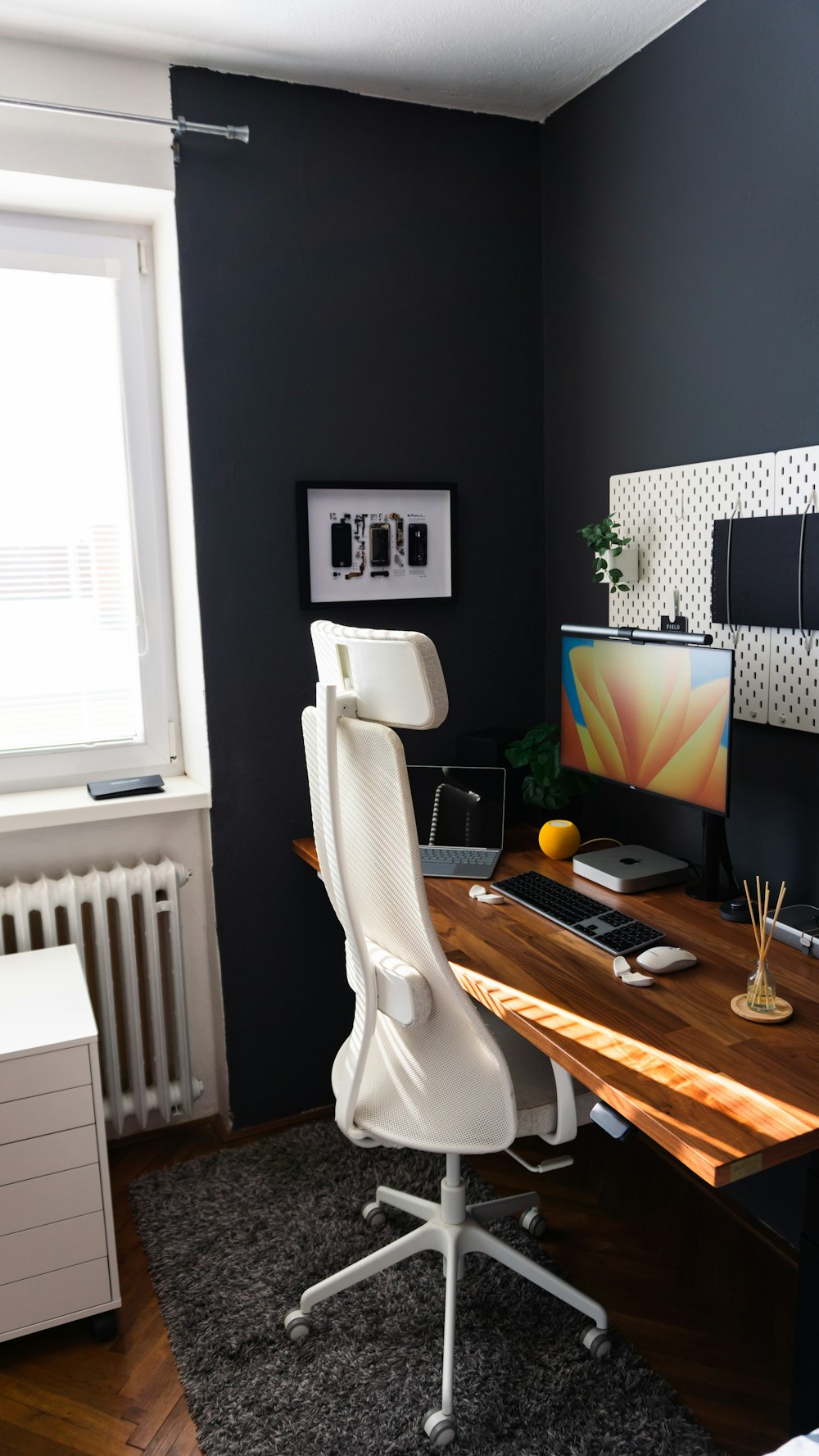 a desk with a computer on it in a room