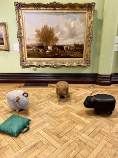 An overhead shot of a crafts with cows event showing guests painting and creating with cows nearby.